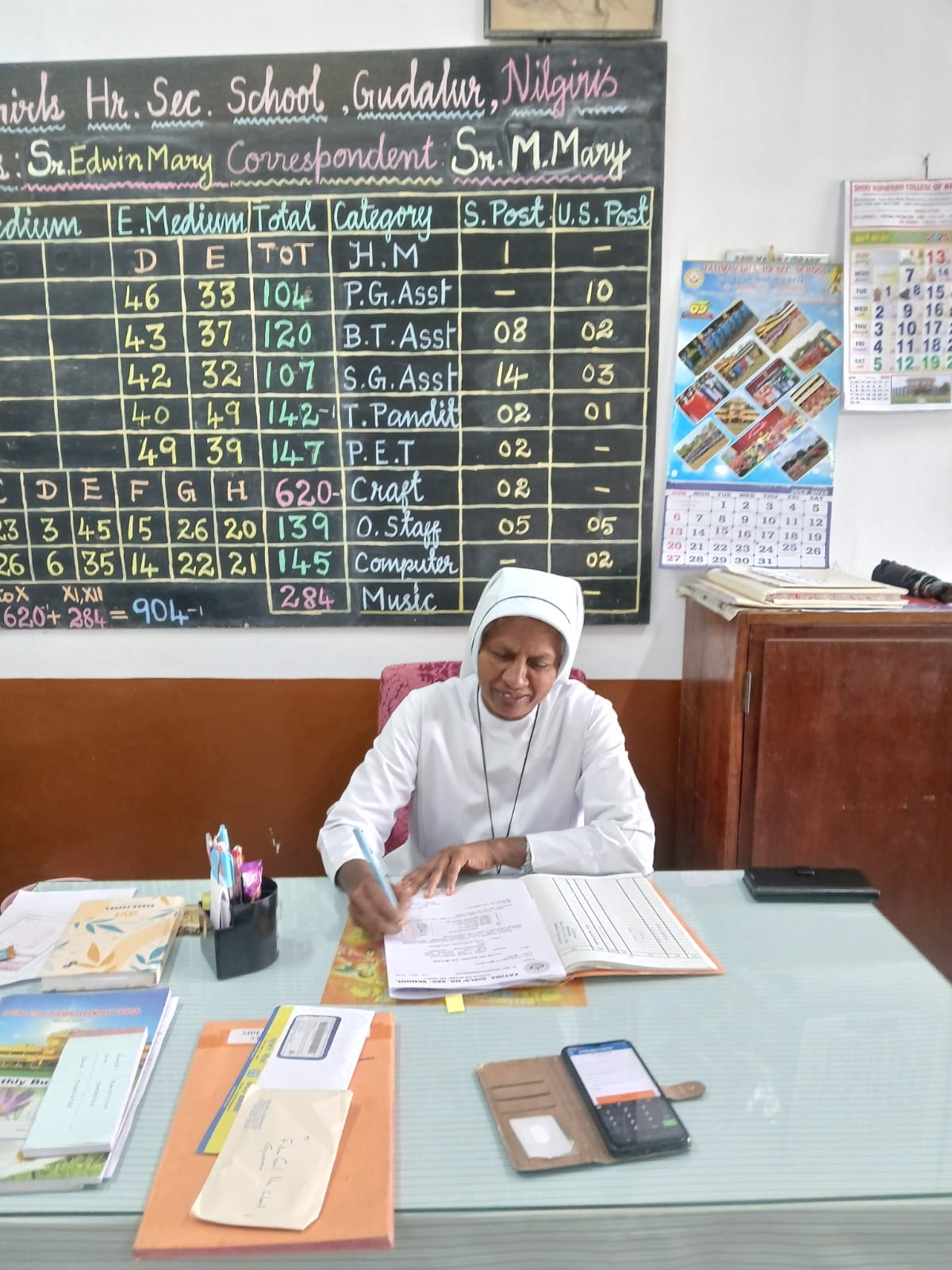 Sr. Sheela working at her desk